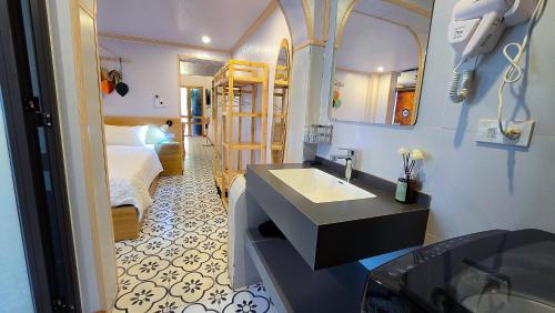 a bathroom with a sink and a bedroom with a bed at AM's Home in Ninh Binh