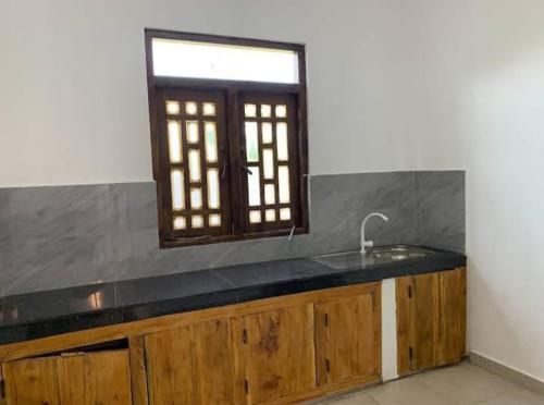 a kitchen with a sink and a window at Ceylon Seaway Villa in Trincomalee