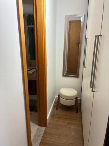 a small bathroom with a toilet and a mirror at Lake view in Brasília