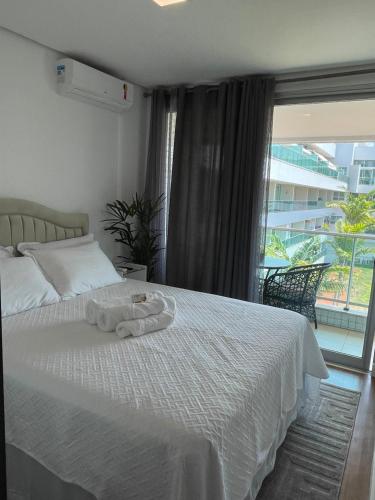 a bedroom with a bed with a towel on it at Lake view in Brasília