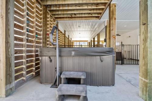 a room with a sink and a stool at Pool Spa Fire Pit & More at this OKI Escape in Oak Island