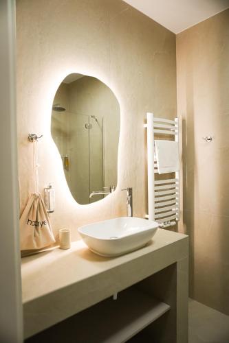 a bathroom with a white sink and a mirror at Moment in Strzelce Opolskie
