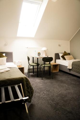 a bedroom with a bed and a table and chairs at Moment in Strzelce Opolskie