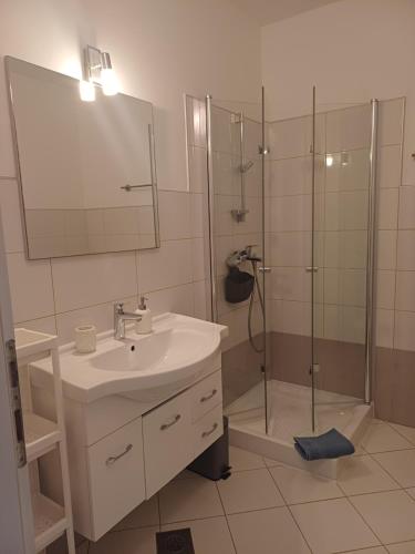 a bathroom with a sink and a shower at Studio Apartment Ivo in Cres