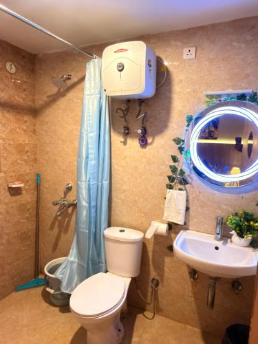 a bathroom with a toilet and a sink at Laugh-Tales in Mathura