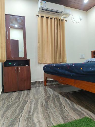 a room with a blue couch and a mirror at Samudra Nadi Bliss in Mūlki
