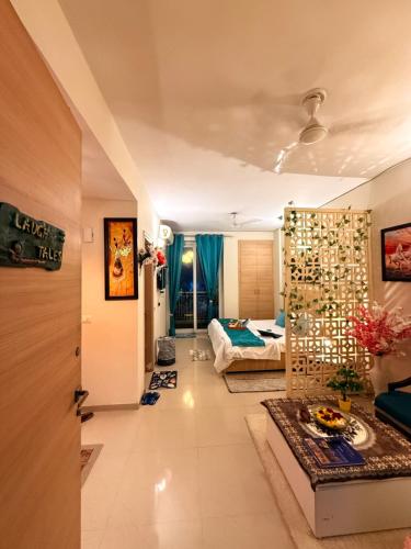 a living room with a bedroom and a bed at Laugh-Tales in Mathura