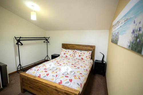 a bedroom with a wooden bed in a room at 52a Albert Street in Kirkwall