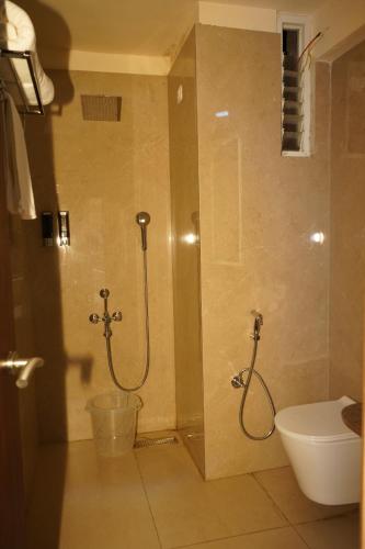 a bathroom with a shower and a toilet at DNC Shevaroys Resorts & Spa in Yercaud