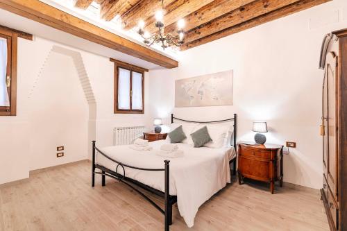 a bedroom with a large bed and a wooden ceiling at Armida Flat by Fenix in Venice