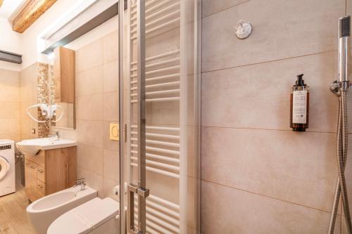 a bathroom with a shower and a toilet and a sink at Armida Flat by Fenix in Venice