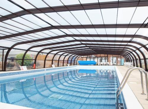 an indoor swimming pool with a glass ceiling at The Harbour Post at Waterside Park in Corton