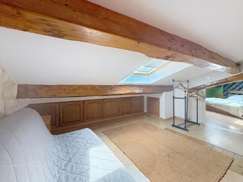 a bedroom with a bed and a vaulted ceiling at La Petite Riau in Seillonnaz