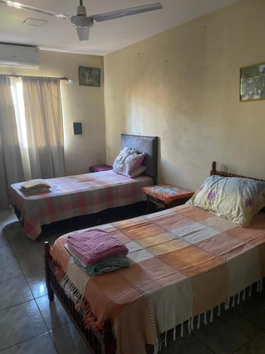 a room with two beds and a window at Roberto in Posadas