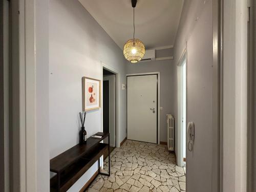 a hallway with a console table and a light fixture at Casa Serena in Baveno