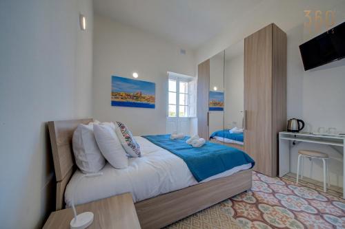 a bedroom with a large bed and a television at Private Room in Hamrun HMR006 in Hamrun