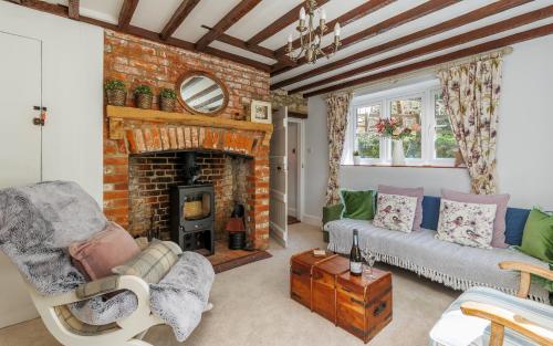 a living room with a couch and a fireplace at 1 Apse Castle Cottage - Chocolate Box Cottage, Pet-Friendly 16th Century Cottage, surrounded by Ancient Woodland in Shanklin in Shanklin