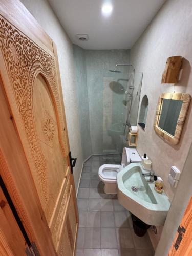 a bathroom with a sink and a toilet at Manapany Surf Camp in Tamraght Ouzdar
