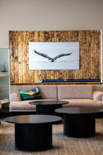a living room with a couch and tables and a clock at Sel - Hótel Mývatn in Myvatn