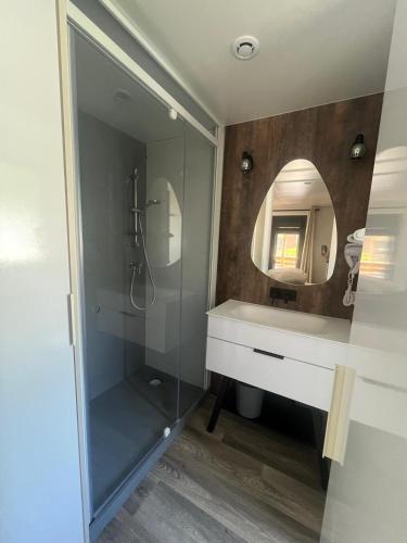 a bathroom with a sink and a mirror at Camping La Marmotte in Ax-les-Thermes