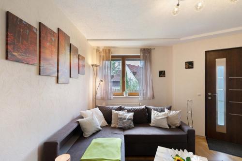 a living room with a couch and a window at Ferienwohnung Hochspessart in Rothenbuch