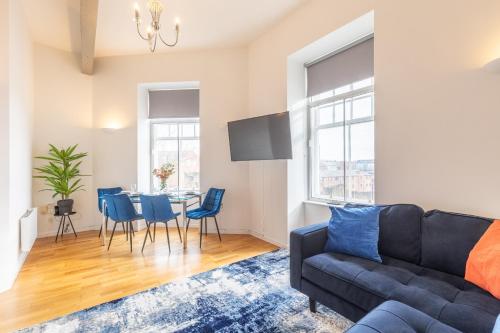 a living room with a couch and a table at The Loft - Properties Unique in Newcastle upon Tyne