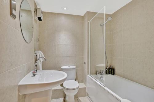 a bathroom with a sink and a toilet and a bath tub at The Loft - Properties Unique in Newcastle upon Tyne