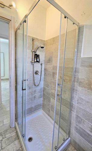 a shower with a glass door in a bathroom at Serendipity, La Caletta in La Caletta