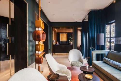 a living room with a couch and chairs at Hotel Montalembert in Paris