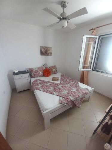 a small bedroom with a bed and a window at Bay View Escape in Igalo