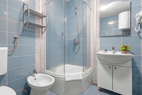 a bathroom with a shower and a toilet and a sink at Lotus Oliva Apart in Premantura