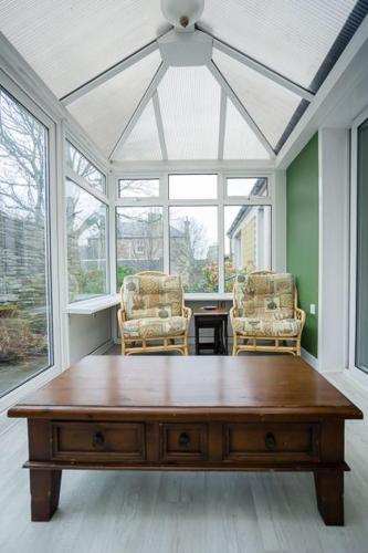 a living room with a wooden table and two chairs at 54a Albert Street, Kirkwall, Orkney - OR00603F in Kirkwall