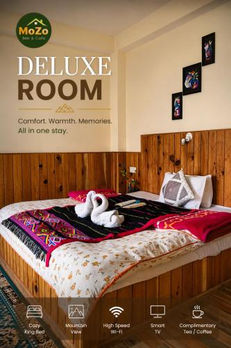 a poster of a bed with two swans on it at MOZO Inn&Cafe Jibhi in Banjār