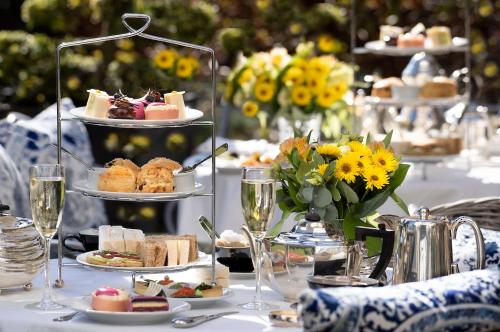 a table topped with plates of food and glasses of wine at Prestonfield House in Edinburgh