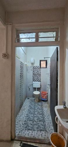 a bathroom with a toilet and a sink at Godavari Lodge in Solapur