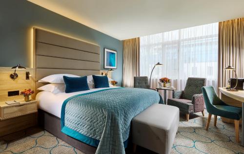 a hotel room with a large bed and a desk at Mespil Hotel in Dublin