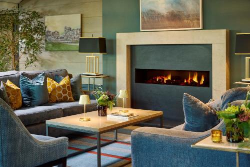 a living room with couches and a fireplace at Mespil Hotel in Dublin