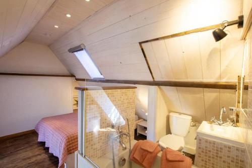 a bathroom with a bed and a sink and a toilet at La pomponnaise in Saint-Pompont