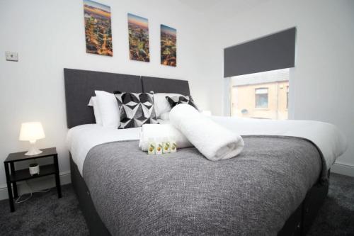 a bedroom with a large bed with pillows on it at Borough Street in Port Talbot