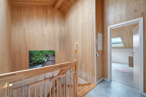 a room with wood paneling and a wall with a television at Ferienhaus Seewald in Seewald