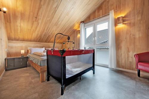 a bedroom with a bed in a room with a window at Ferienhaus Seewald in Seewald