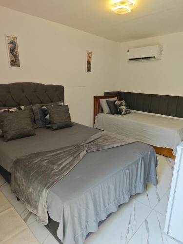 a bedroom with two beds at Suites Du'Mauro Terreo in Abraão