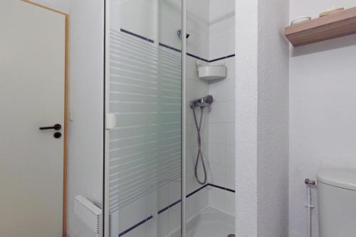 a shower with a glass door in a bathroom at Aux Gourbets - Conciergerieland in Vieux-Boucau-les-Bains