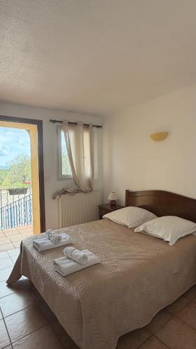 a bedroom with a large bed with towels on it at Ferme de Sejour Rebuffel in La Roque-Esclapon