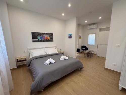 a bedroom with a bed with two towels on it at OTB ITALIA - Airport Rooms in Treviso