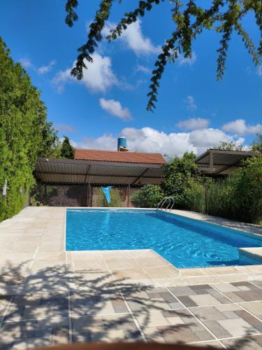 a swimming pool in the backyard of a house at Cabañas Thijada in Mina Clavero