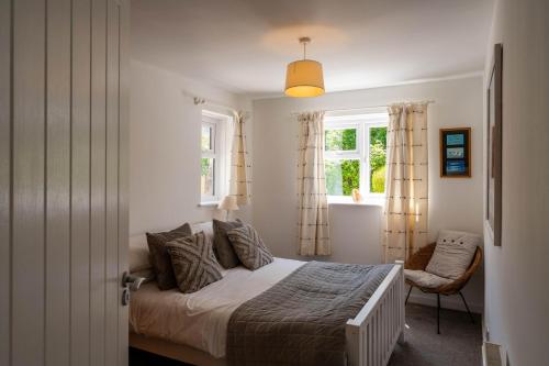 a bedroom with a bed and a window at Chuggs Orchard in Croyde