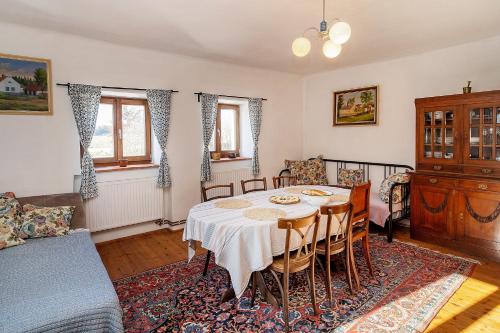 a dining room with a table and a couch at Apartmán U babičky in Strakonice