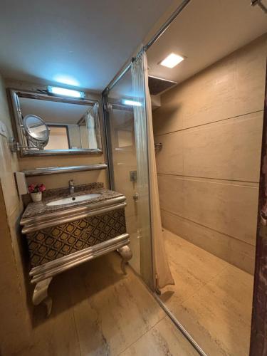 a bathroom with a sink and a mirror at Golden Chariot Vasai Hotel in Vasai