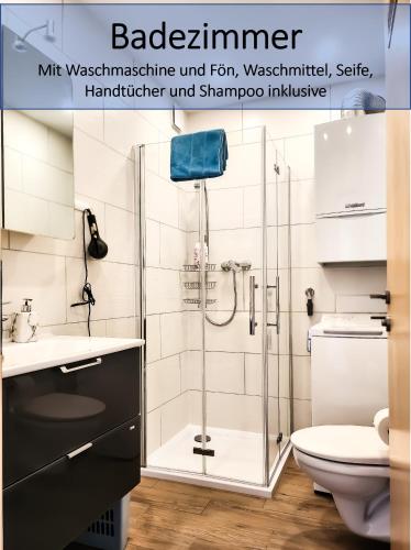 a bathroom with a shower and a sink and a toilet at My FeWo in Germersheim